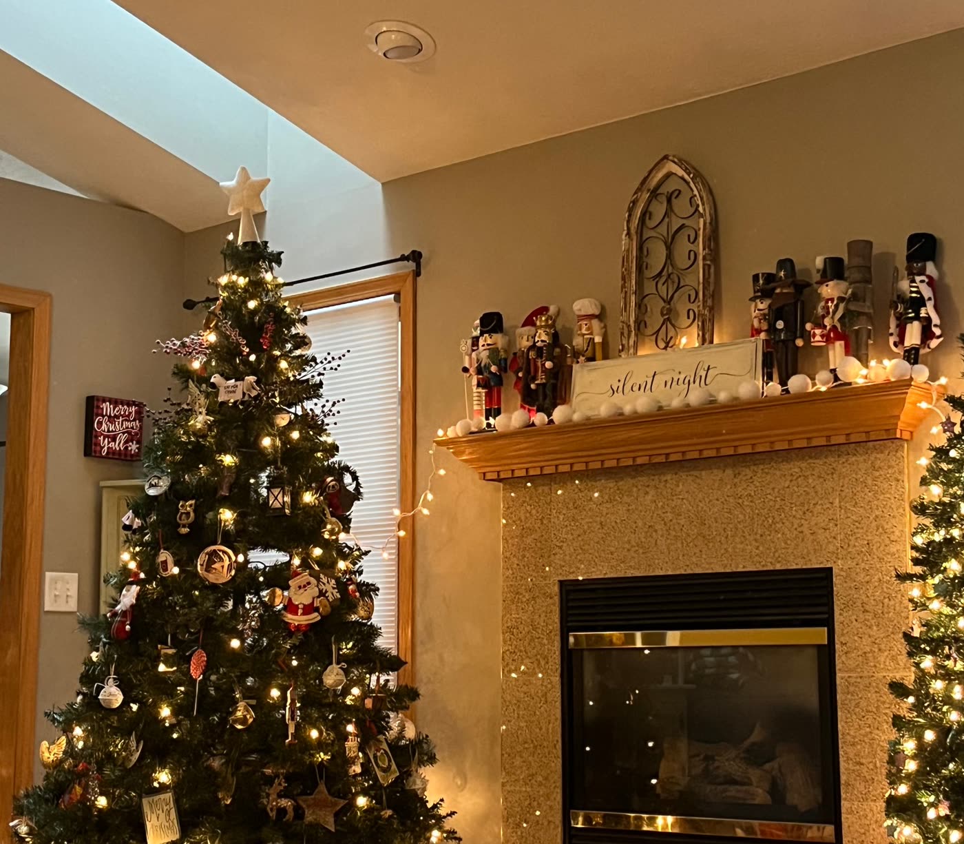 Santa's Workshop: a decorated Christmas tree beside a fireplace with a mantel of nutcrackers